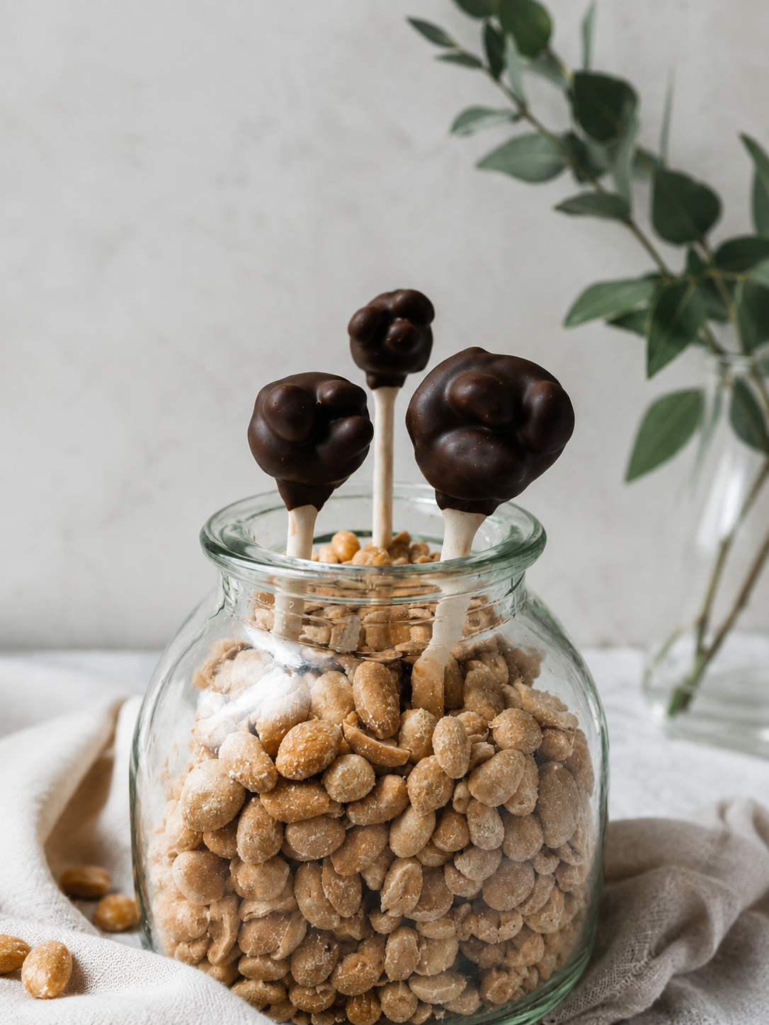 Auf diesem Bild sieht man ein gesundes Dessert, nämlich Bananen-Schokolade-Erdnussmus-Lollies